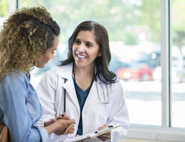  A woman talks with her doctor