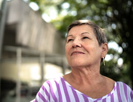 A woman gazes at the sky.