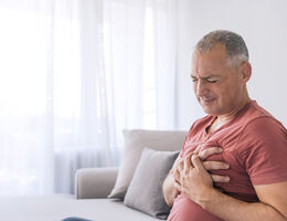 A man clutching his chest over his heart.