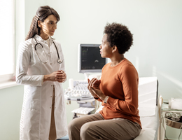 A woman talks to her doctor