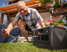 A man checks the charge on a portable power station.